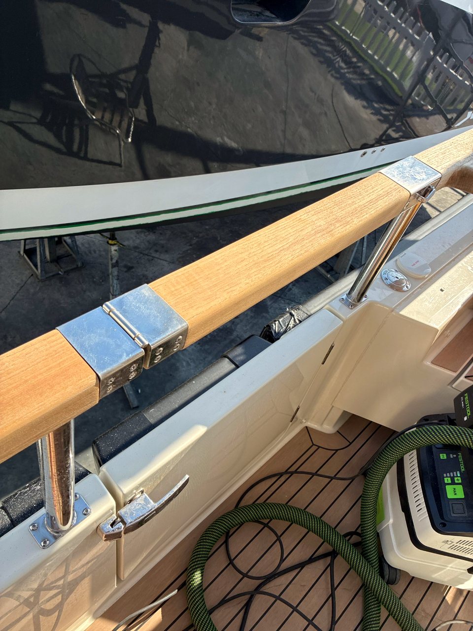 Bare, sun-greyed teak handrail