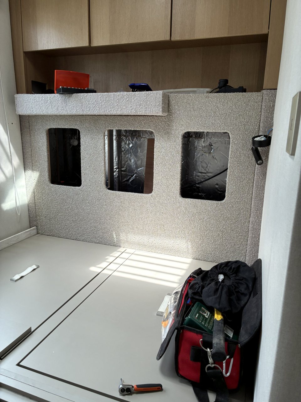Storage openings, carpet-lined and trimmed