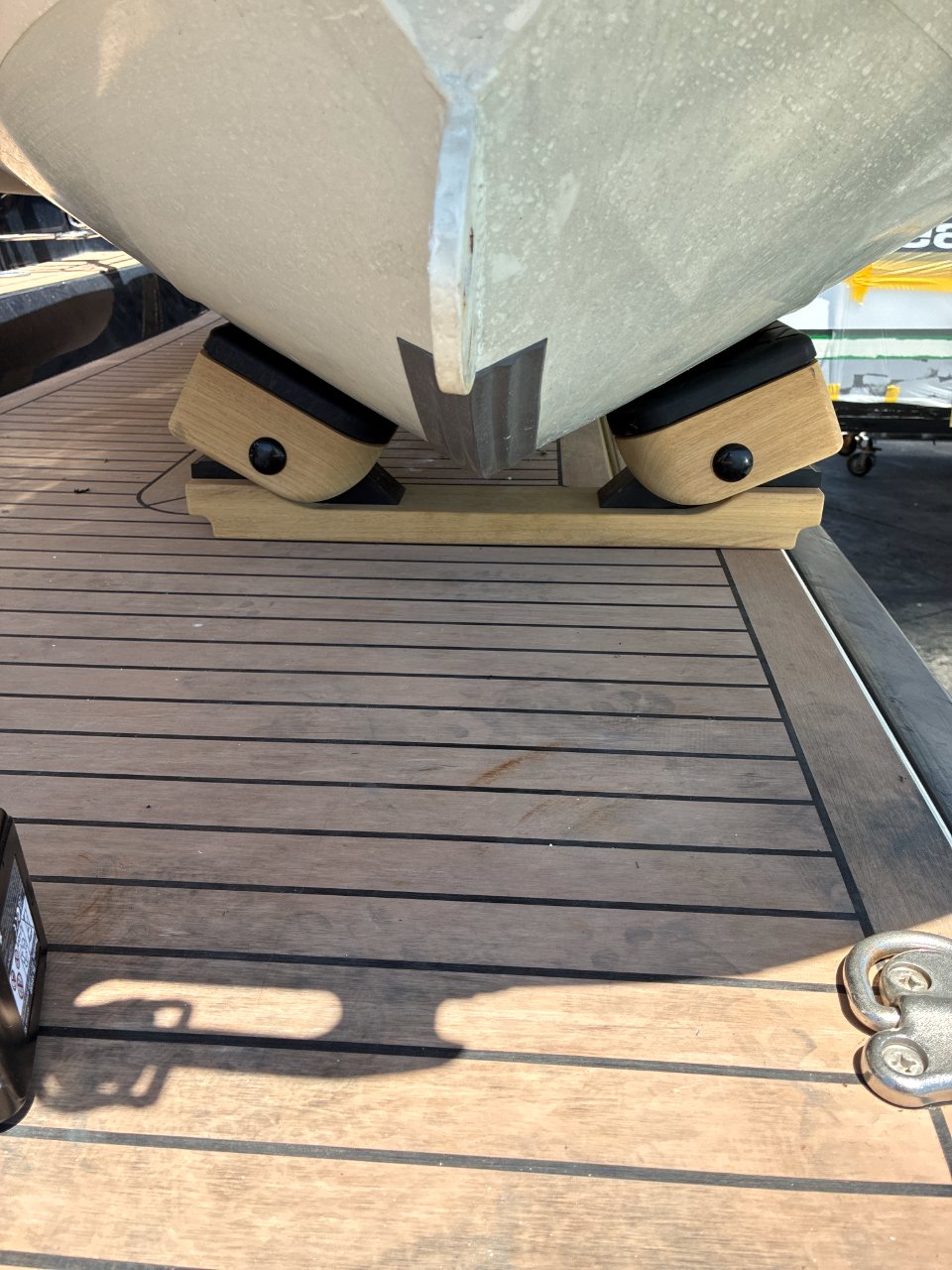 Custom teak chocks, shaped to cradle the hull